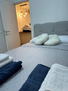 a bedroom with a bed with two pillows on it at VIP House 5 in Vrnjačka Banja