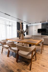 a dining room with a wooden table and chairs at Goldhill villa in Yaremche