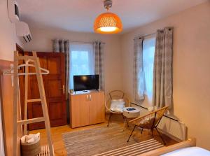 a bedroom with a bunk bed and a living room at Kucica Yuva in Vrnjačka Banja