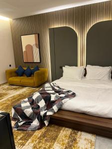 a bedroom with a bed with a blanket on it at محمد هوم in Al Hofuf