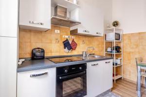 a small kitchen with a sink and a stove at Luminoso Appartamento con Balcone & ParcheggioFree in La Spezia