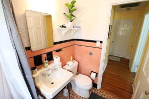 a bathroom with a sink and a toilet and a mirror at Lofty Elegant Home • Downtown Princeton • 3BR in Princeton +34 photos