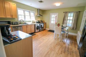 a kitchen with a counter and a table with chairs at Lofty Elegant Home • Downtown Princeton • 3BR in Princeton