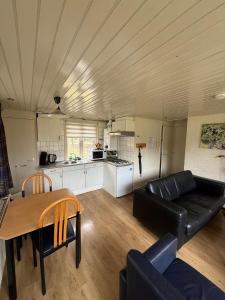 a living room with a couch and a table at Vosseven 15 Haasje in Stramproy