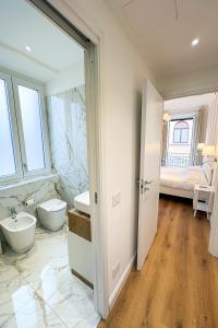 a bathroom with a sink and a toilet and a tub at Dimore della Cisterna in Stresa +48 photos