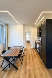 a kitchen and dining room with a table in a room at Dimore della Cisterna in Stresa