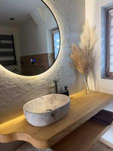 a bathroom with a large stone sink in front of a mirror at Domek u Łowiszów in Dzianisz +4 photos