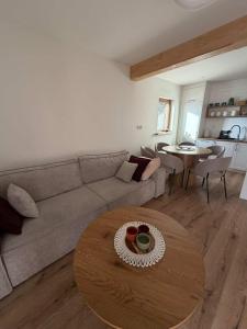 a living room with a couch and a table at Domek u Łowiszów in Dzianisz