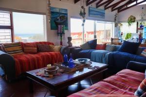 a living room with couches and a coffee table at The Wilderness Way in Wilderness +14 photos
