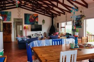 a living room with a table and blue chairs at The Wilderness Way in Wilderness