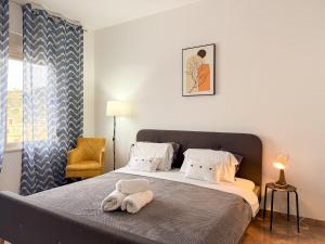 a bedroom with a bed and a chair at LunaSol seaside Apartments in Durrës