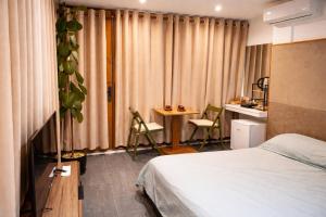 a hotel room with a bed and a table and chairs at Beus home in Durrës