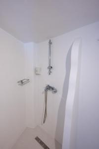 a shower in a white room with a sink at Silver Lining in Akrotiri +16 photos