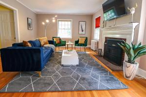 a living room with a blue couch and a fireplace at Lofty Elegant Home • Downtown Princeton • 3BR in Princeton