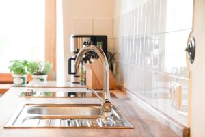 a kitchen sink with a faucet on a counter at Biohof Pürten in Waldkraiburg