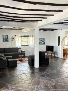 a living room with a couch and a table at Mango House Watamu in Watamu