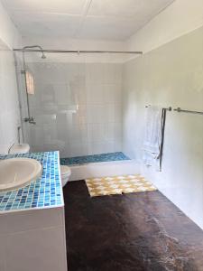 a bathroom with a tub and a toilet and a sink at Mango House Watamu in Watamu +4 photos
