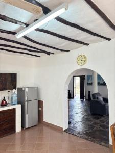 a kitchen and living room with a clock on the ceiling at Mango House Watamu in Watamu