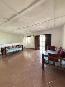 a large room with couches and tables in it at Mango House Watamu in Watamu