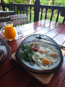 a table with a plate of fruits and vegetables on it at Kitka Hostel - Guest House in Tetovo