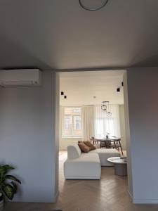 a living room with a white couch and a table at Allies Avenue in Leuven