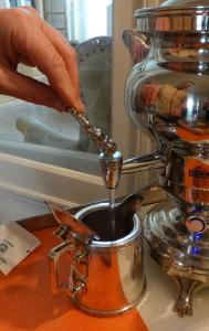 a person is pouring coffee into a pot at Guesthouse PPP in Ghent +54 photos