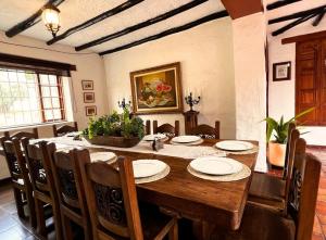 a dining room with a wooden table and chairs at La Franchesca Hotel Boutique in Tabio +51 photos