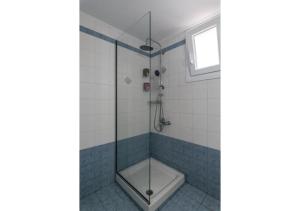 a bathroom with a shower with a glass door at Stella's Mandrakia Seaside House in Mandrakia +14 photos