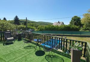 a patio with chairs and tables on a fence at Sziklaszirt - Wellness Vendégház in Salgótarján