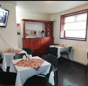 a restaurant with two tables and chairs and a window at Hotel Bello, Andrés Bello 1166 in Temuco