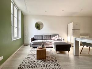 a living room with a couch and a table at CASA TULUM in Cognac