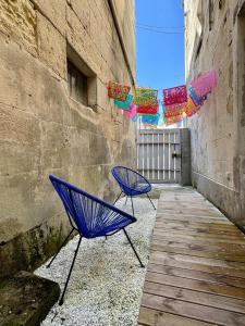 two blue chairs sitting next to a building at CASA TULUM in Cognac