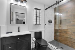 a bathroom with a toilet and a sink and a shower at Lounges at Lynchburg in Lynchburg
