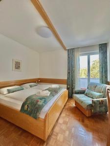 a bedroom with two beds and a couch and a window at Porto MarIn Strašek in Portorož