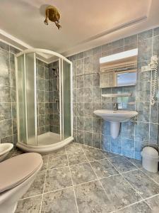 a bathroom with a shower and a toilet and a sink at Porto MarIn Strašek in Portorož