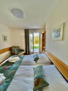 a bedroom with three beds with pillows on the floor at Porto MarIn Strašek in Portorož +32 photos