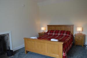a bedroom with a bed and two night stands with two lamps at Number 2 in Montrose