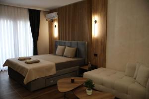 a hotel room with a bed and a couch at Hotel and Coffee Bar Old Bazaar in Skopje