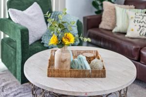 a coffee table with a vase with flowers on it at Endless Sunset- Near Beach Surf and Pet Friendly in Huntington Beach