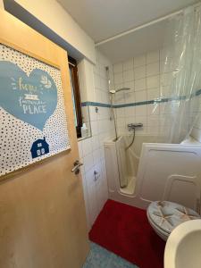 a bathroom with a toilet and a shower and a sink at Ferienwohnung Löffel-Lodge in Heimbach +13 photos