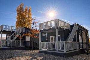 a house with two decks and the sun in the sky at Ultra Luxury Tiny Home with Deck in Page