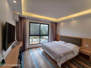 a bedroom with a large bed and a large window at Cloud 9 Resort Hotel in Yangchang
