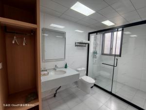 a bathroom with a sink and a toilet and a shower at Cloud 9 Resort Hotel in Yangchang +12 photos