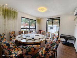 a room with a table and chairs and a piano at Cloud 9 Resort Hotel in Yangchang