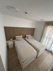 a bedroom with two beds and a window at Marina Rey Aparthotel Playa de Puerto Rey in Vera +9 photos