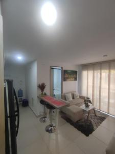 a living room with a couch and a table at Via Tayrona in Santa Marta +8 photos