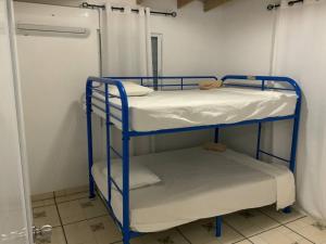 two bunk beds in a room with a door at Cabin Retreat for Group with Pool in Cabo Rojo +5 photos