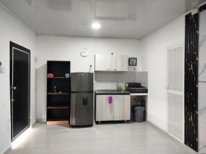 a kitchen with a stainless steel refrigerator in a room at Apartaestudio Marbella #2-10 in Cartagena de Indias