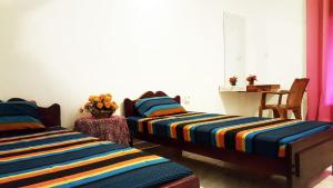 Postel nebo postele na pokoji v ubytování Kassapa Home Stay