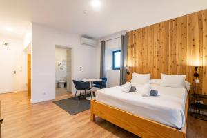 a bedroom with a large bed with a wooden wall at Vila Rosario in Ponta Delgada +247 photos